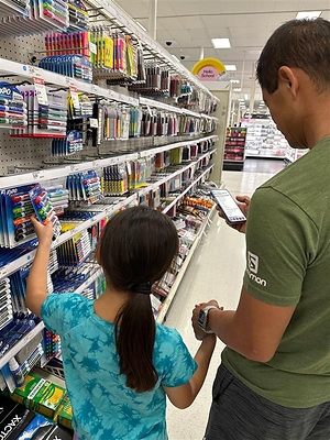 Family shopping for school supplies in-store using the TeacherLists online tool
