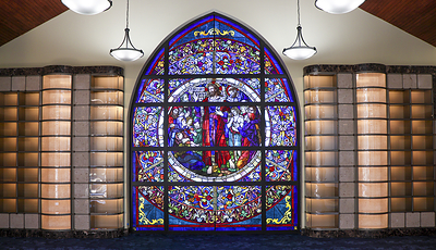 Stained-glass sanctuary — The Peacemaker stained-glass window is a radiant place for prayer and remembrance inspired by the Sermon on the Mount, also known as the Beatitudes. The Peacemaker stained-glass window is installed on the second floor in the new cremation chapel on the opposite side of the mosaic. The window, saved from the former Sacred Heart Church in Vailsburg, a neighborhood in northern Newark, NJ, depicts Christ with the 12 apostles.

