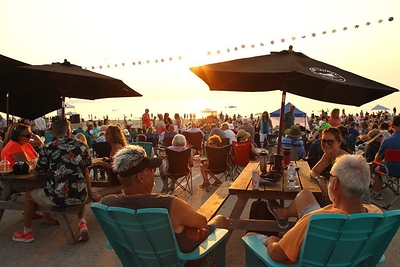 Visitors and residents enjoying Town programming and live music near Beach Area 1 in Wasaga Beach, Ontario, Canada. Wasaga Beach is home to the world's longest (14 kilometre) freshwater beach and has had a renewed focused on growing sustainable tourism since 2023. Tourism has continued to increase steadily as a result of Council advocacy and targeted investments in infrastructure, destination events and destination marketing.