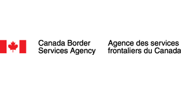 A vehicle lane at a small rural Alberta–U.S. land border crossing on the southern prairie.
