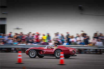 A 1958 Ferrari Testa Rossa demonstrates on the Simeone Museum tarmac during the 2025 24 Heures du Simeone. The fourth annual event returns June 13-14, 2026, featuring more than 40 historic car demonstrations, live coverage of the 24 Hours of Le Mans in France, and overnight camping on site. An official partner event of the Automobile Club de l'Ouest.