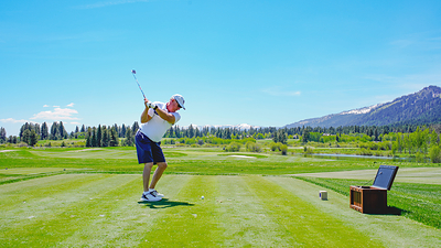 A golfer practices his swing surrounded by the beautiful vistas at Osprey Meadows Golf Course.