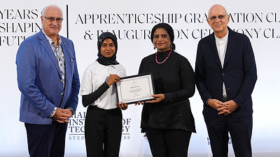 Fathimath Saraa receives her graduation certificate during the Class of 2026 ceremony