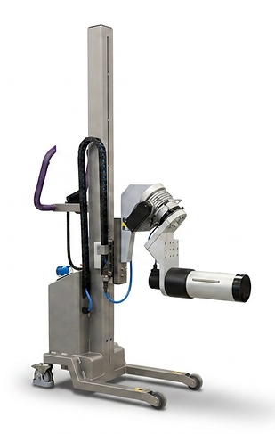 Stainless-steel Packline lifter handling a large pharmaceutical film roll with a motorised 6-inch spindle attachment in a clean, hygienic production environment.
