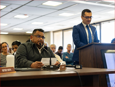 Jose Andrade Peña, a stonecutter for 33 years diagnosed with advanced artificial stone silicosis, left, delivers a testimony about his illness during a presentation on silica at an Occupational Safety and Health Standards Board (OSHSB) meeting. (Gina Castro for KQED)