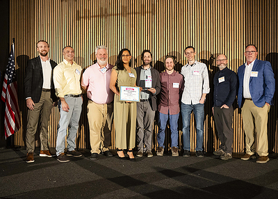 The BookBaby print production team accepting their award.