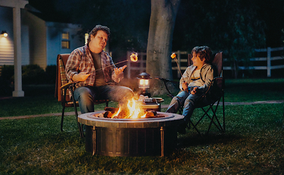 Hershey's partner and s'mores icon Patrick Renna and son, Flynn Renna, roasting the perfect s'mores together. 