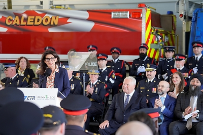 Connie Dejak, President & CEO, Runnymede Healthcare Centre, speaks at the Caledon Fire Hall alongside first responders and government representatives, including Premier Ford.