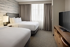 Renovated double queen guest room at Embassy Suites by Hilton Lexington/UK Coldstream featuring contemporary furnishings, upgraded finishes, and enhanced comfort for business and leisure travelers.