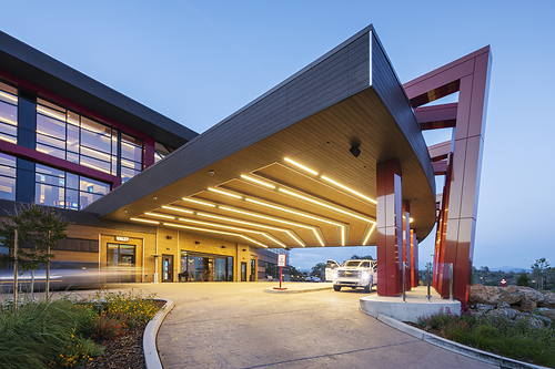 Nichiha VintageWood clads the dramatic canopy soffit of this porte-cochère, delivering the warmth and shadow lines of natural wood grain with the long-term durability and weather resistance of fiber cement. Nichiha VintageWood clads the dramatic canopy soffit of this porte-cochère, delivering the warmth and shadow lines of natural wood grain with the long-term durability and weather resistance of fiber cement.