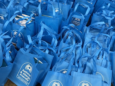 300 Asthma & Allergy Friendly® Resource Tote Bags, packed with educational materials and Certified partner contributions for distribution across Chicago communities, May 2026.