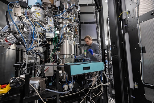 Biohub engineer Pavel Olshin makes adjustments to the laser phase plate cavity inside a cryo-electron microscope. (Credit: Dale Ramos/Biohub)
