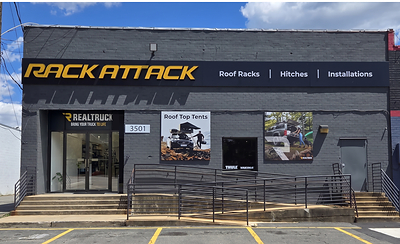 RealTruck product posters displayed on the exterior of Rack Attack store.
