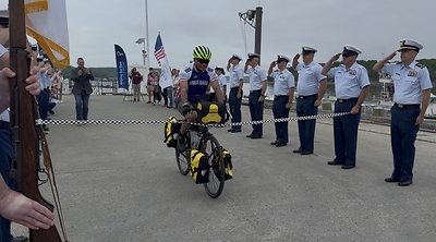 Retired Vice Adm. Manson K. Brown crosses the finish line in Bar Harbor, Maine, on June 11, 2026, completing a more than 2,170-mile ride from Key West, Florida, to raise support for Coast Guard families through Coast Guard Mutual Assistance. Photo courtesy of Coast Guard Mutual Assistance.