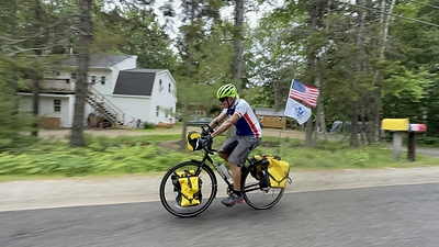 Retired Vice Adm. Manson K. Brown rides into Bar Harbor, Maine, on June 11, 2026, completing a solo, unsupported bicycle journey from Key West, Florida, to raise awareness and support for Coast Guard families through Coast Guard Mutual Assistance. Photo courtesy of Coast Guard Mutual Assistance.