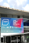 Exterior of FESPA 2026 venue with a large blue and pink 'The Place for Experts' banner above the entrance doors and a KOINTEC logo overlay.