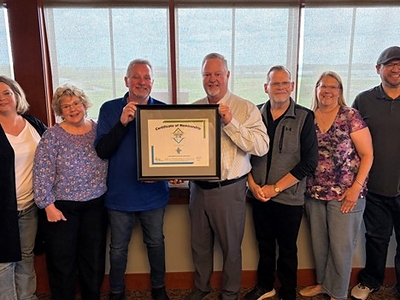DIPRA Regional Engineer David Billings (center) presents a certificate honoring the City of Hammond, IN, for choosing cast iron pipe more than 100 years ago for its drinking water system. City personnel also appearing in the photo, from left to right, are Tammy Pramuk, Lead AP/Deputy Operations Supervisor; Deborah VanMeter, Office Manager; Bruce Long, Distribution Superintendent; Billings; Charles Pietrucha, Filtration Superintendent; Sharon Daniels, President, Board of Directors; and Jaime Prieto, Deputy Chief Executive Operator