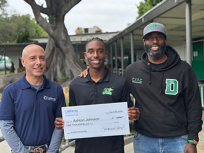 L/R: California Credit Union VP/West LA Branch Manager Richard Cowell presents a California Credit Union Foundation scholarship to Susan Miller Dorsey High School graduate Ashton Johnson, with Susan Miller Dorsey High School Principal Orlando M. Johnson. Ashton will attend Loyola Marymount University studying Business Management in the fall.