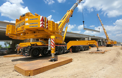 LiftHigh Crane & Rigging performs a tandem lift using a 900-ton and 400-ton Liebherr crane to place bridge beams on a Texas infrastructure project.