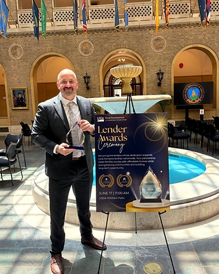 Jake Vehige, President of Neighbors Bank, accepts the USDA Rural Development Top Origination Award on July 17th, 2026 on behalf of the Neighbors Bank team. 