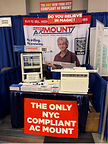 Inventor Peter Allen showcasing the "Magic AC Mount" – the only NYC-compliant mounting solution that requires no drilling.