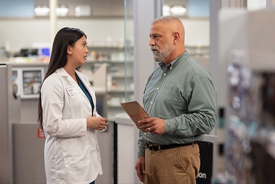 CVS pharmacist consulting with patient.