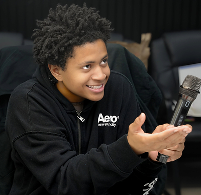 GDLU youth smiling and having a "mic drop" moment.