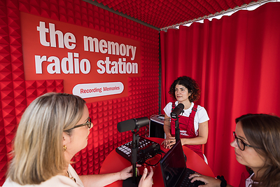 Visitors participate in Synthetic Memories at The Memory Radio Station, a travelling public radio station and exhibition launched by Eli Lilly and Company at the European Academy of Neurology (EAN) Congress on 26 June 2026 in Geneva, Switzerland. (KEYSTONE/Pierre Albouy)