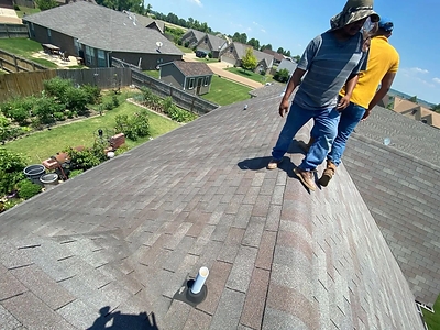 Roof Inspection Crew from Hernandez Services conducting a routine roofing evaluation on a residential property.