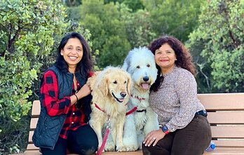 DogHood Co-Founders Purvi Janardhan (right) and Ruchi Joshi (left) sit with Oreo the Sheepadoodle and Nessie the Golden Retriever to celebrate the platform's major hyperlocal product expansion