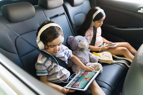 Kids playing Lingokids during a summer road trip. Kids playing Lingokids during a summer road trip.