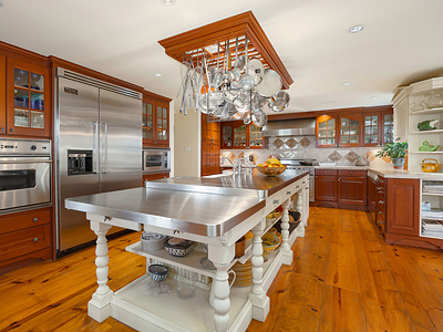 The property’s main residence was originally built in 1865 but has been expanded and thoughtfully upgraded with modern finishes and amenities in recent decades. It offers three living levels, with notable features including a grand salon, library/study, elevator, fitness room, chef’s kitchen (pictured) and formal dining room able to host up to 30 dinner guests. HudsonValleyLuxuryAuction.com.