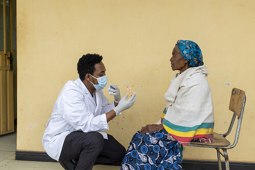 In Arba Minch, Ethiopia, Dr. Basliel, an Orbis-trained surgeon, examines patient Mosho, 85, after performing a successful cataract surgery. Photo: Jenny Barker In Arba Minch, Ethiopia, Dr. Basliel, an Orbis-trained surgeon, examines patient Mosho, 85, after performing a successful cataract surgery. Photo: Jenny Barker