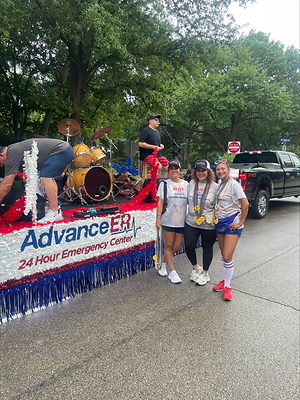 Advance ER team members pose in front of the organization's Fourth of July parade float before the start of the Park Cities Fourth of July Parade. The float featured a live performance by The Rust Band and highlighted Advance ER's ongoing commitment to serving the Park Cities community.