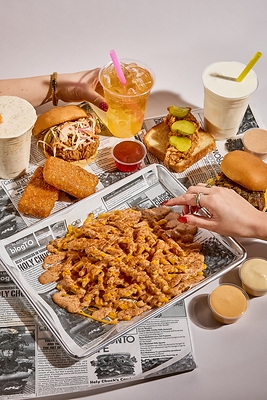 Fried chicken sandwiches, loaded fries drenched in house sauce, cheese pulls and dirty sodas. Holy Chuck brings the whole spread to the table.