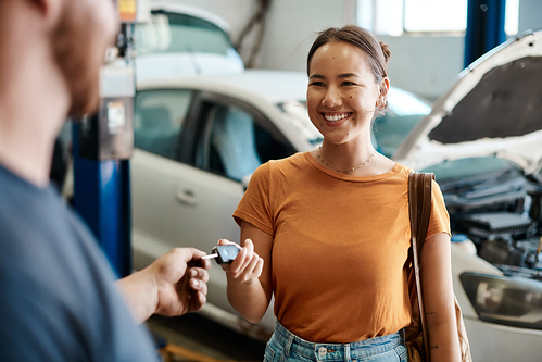 Women handing keys to a mechanic