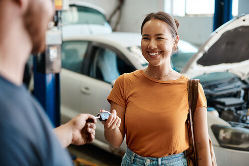 Women handing keys to a mechanic