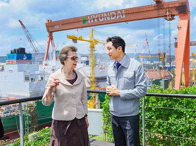 Britain’s Princess Anne and HD Hyundai Chairman Chung Kisun speak with each other at HD Hyundai Heavy Industries' Ulsan shipyard.