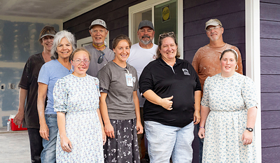 Brandy Cajudoy, construction manager for Ho‘ola ia Mauiakama, second from right, takes photos with volunteers from Mennonite Disaster Services at one of the project sites in Lāhainā, Hawai’i. Photo credit: Mengshin Lin Brandy Cajudoy, construction manager for Ho‘ola ia Mauiakama, second from right, takes photos with volunteers from Mennonite Disaster Services at one of the project sites in Lāhainā, Hawai’i. Photo credit: Mengshin Lin