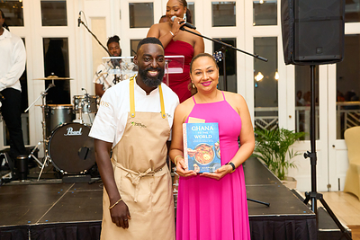 Chef Eric Adjepong Gifting His Cookbook "Ghana to the  World" to Nevis First Lady, Sharon Brantley, at the Nevis Mango Festival's Supper Club Opening Night Dinner at The Four Seasons Nevis