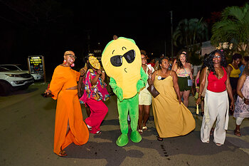 Nevis Mango Festival Mascot with attendees of the Nevis Mango Festival Bar Crawl on Pinney's Beach.