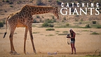 Filmmakers capturing images of a giraffe in South Africa.