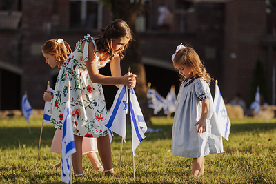A family plants Israeli flags at World Outreach Church in Murfreesboro, Tenn. as part of the Flags of Fellowship event on Oct. 4, 2025. Over 1,350 churches, synagogues and organizations participated in the IFCJ-led campaign last year. Photo Credit: World Outreach Church.