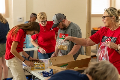 TriStar Bank employees prepare snack packs for individuals served by Kinsmen Redeemer Ministry during a Day of Service Friday, June 19, 2026. 