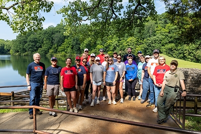 TriStar Bank employees gather at Montgomery Bell State Park to prepare the handrails for a fresh coat of paint during a Day of Service Friday, June 19, 2026. 