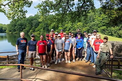 TriStar Bank employees gather at Montgomery Bell State Park to prepare the handrails for a fresh coat of paint during a Day of Service Friday, June 19, 2026. 