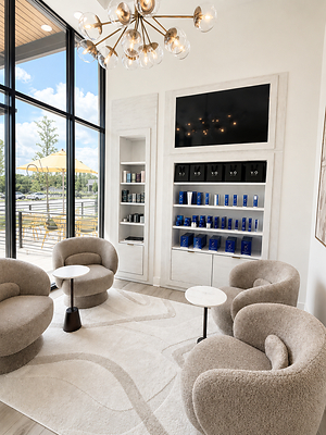 A brighter, hospitality-inspired reception area featuring warm neutral tones, natural materials and layered textures.