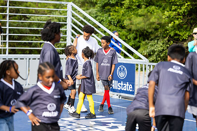 Adams greeted dozens of children participating in a youth clinic at the mini-pitch's grand opening