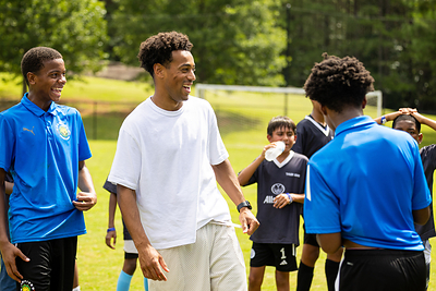 Adams greeted dozens of children participating in a youth clinic at the mini-pitch's grand opening