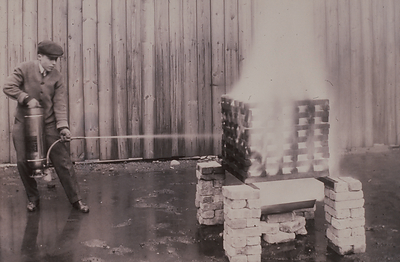 A soda acid fire extinguisher undergoing testing at Underwriters Laboratories, circa 1910s. These extinguishers were the first UL-labeled devices. Photo courtesy of UL Archives.